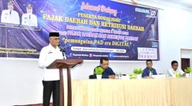Asisten III Setdakab Mandailing Natal Drs. Lismulyadi Nasution, MM saat membacakan kata sambutan pembukaan acara sosialisasi perpajakan dari Bapenda Madina, Rabu (29/5/2024). [Ist]